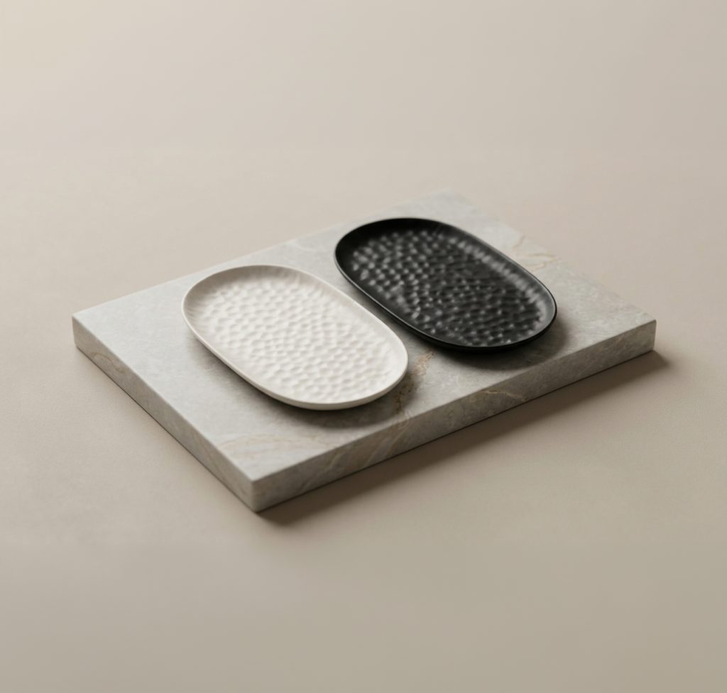 White and Black Dimple Trays side by side on a stone block