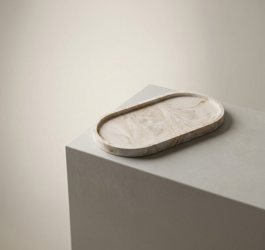 Marbled Oval Tray resting on a stone block